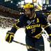Michigan junior defenseman Mac Bennett checks a Notre Dame player on Sunday, March 24. Daniel Brenner I AnnArbor.com